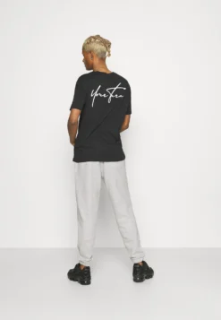 YOURTURN UNISEX - Spodnie Treningowe - Mottled Light Grey -Yourturn 44af697d8af34693a7b3385401313f6d scaled